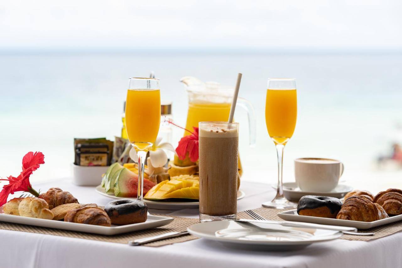 Fresh breakfast with tropical juices by the pool at My Blue Hotel